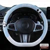 Cute universal leather steering wheel cover with breathable design for cars, by Gm Service Guy, shown on a vehicle's steering wheel.