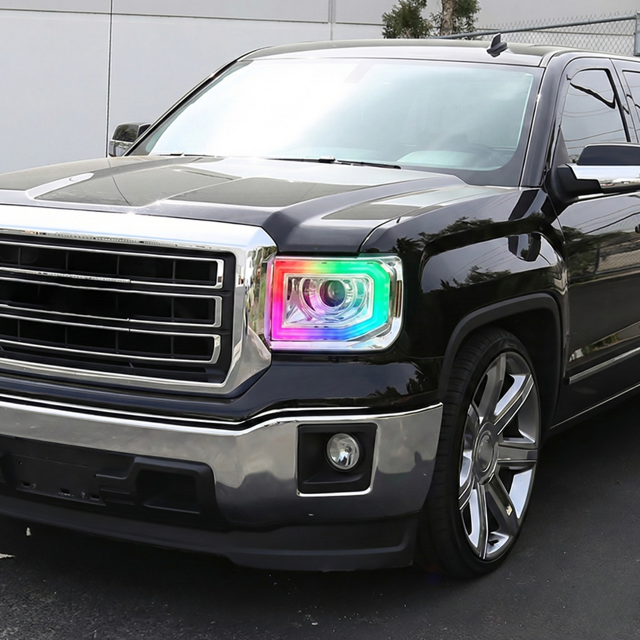 NTXGlow RGB headlights installed on a 2014-2019 GMC Sierra 1500, 2500, 3500 truck showing vibrant lighting effects