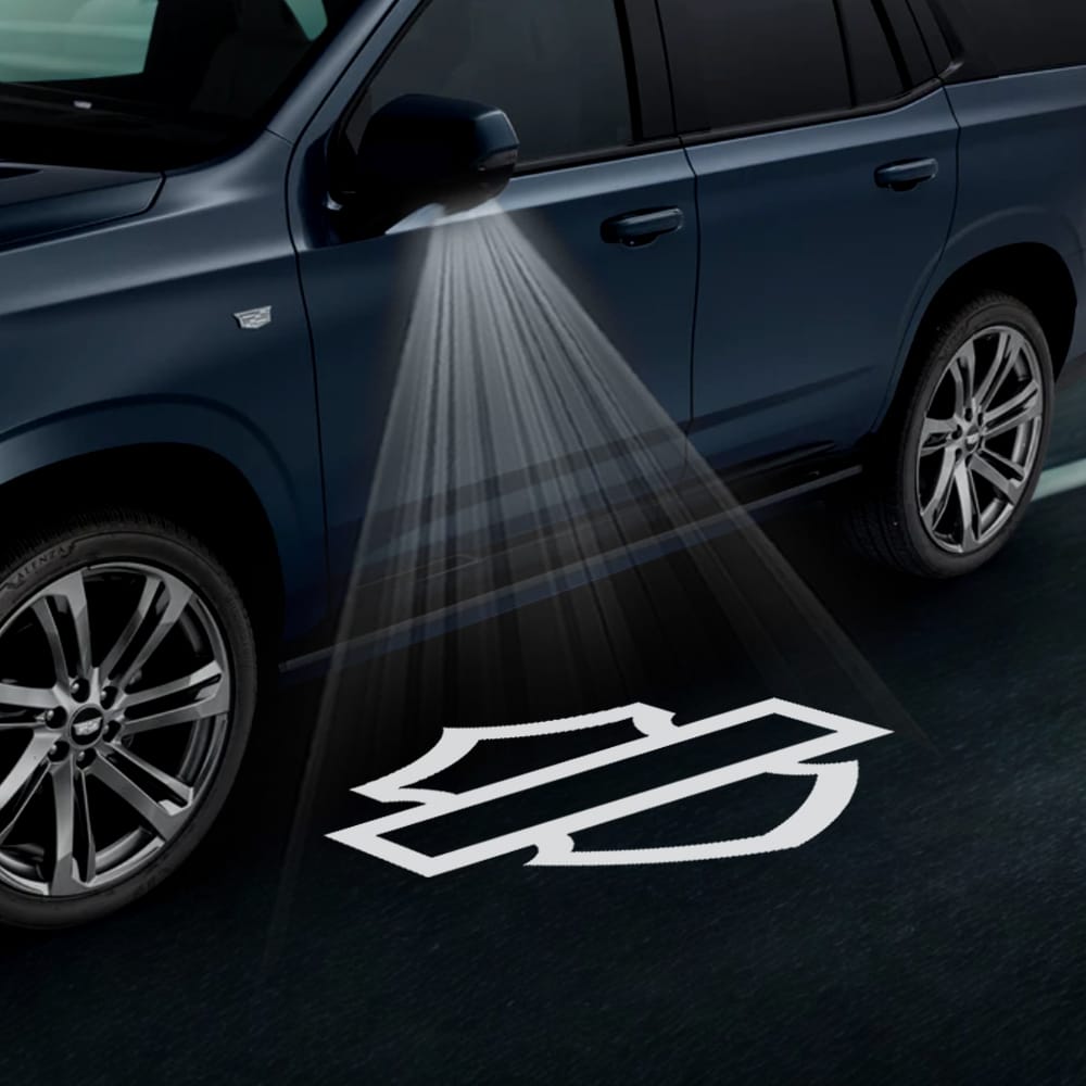 Pair of Cadillac Escalade 4th/5th gen custom side wing mirror projector puddle lights with Harley-Davidson logo, for 2015-2026 models.