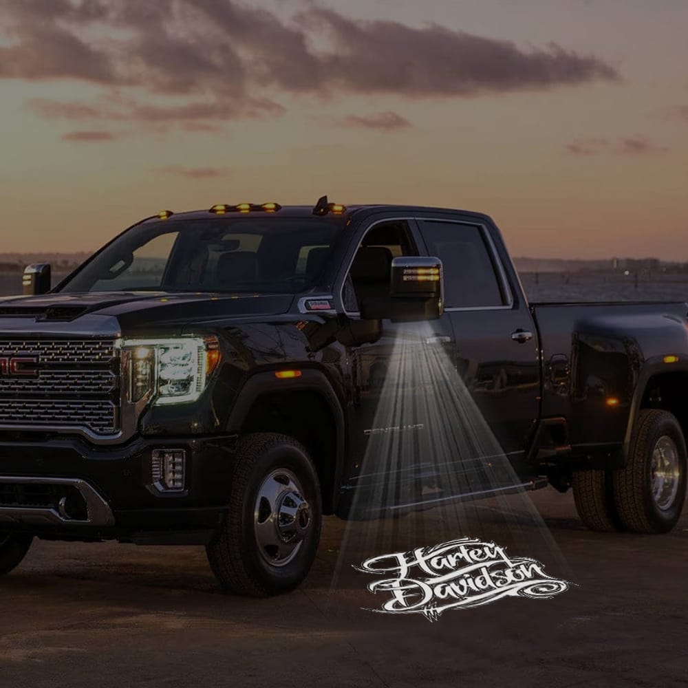 Pair of GMC Sierra custom side wing mirror puddle lights with Harley-Davidson logo, designed for 2015-2026 trucks.